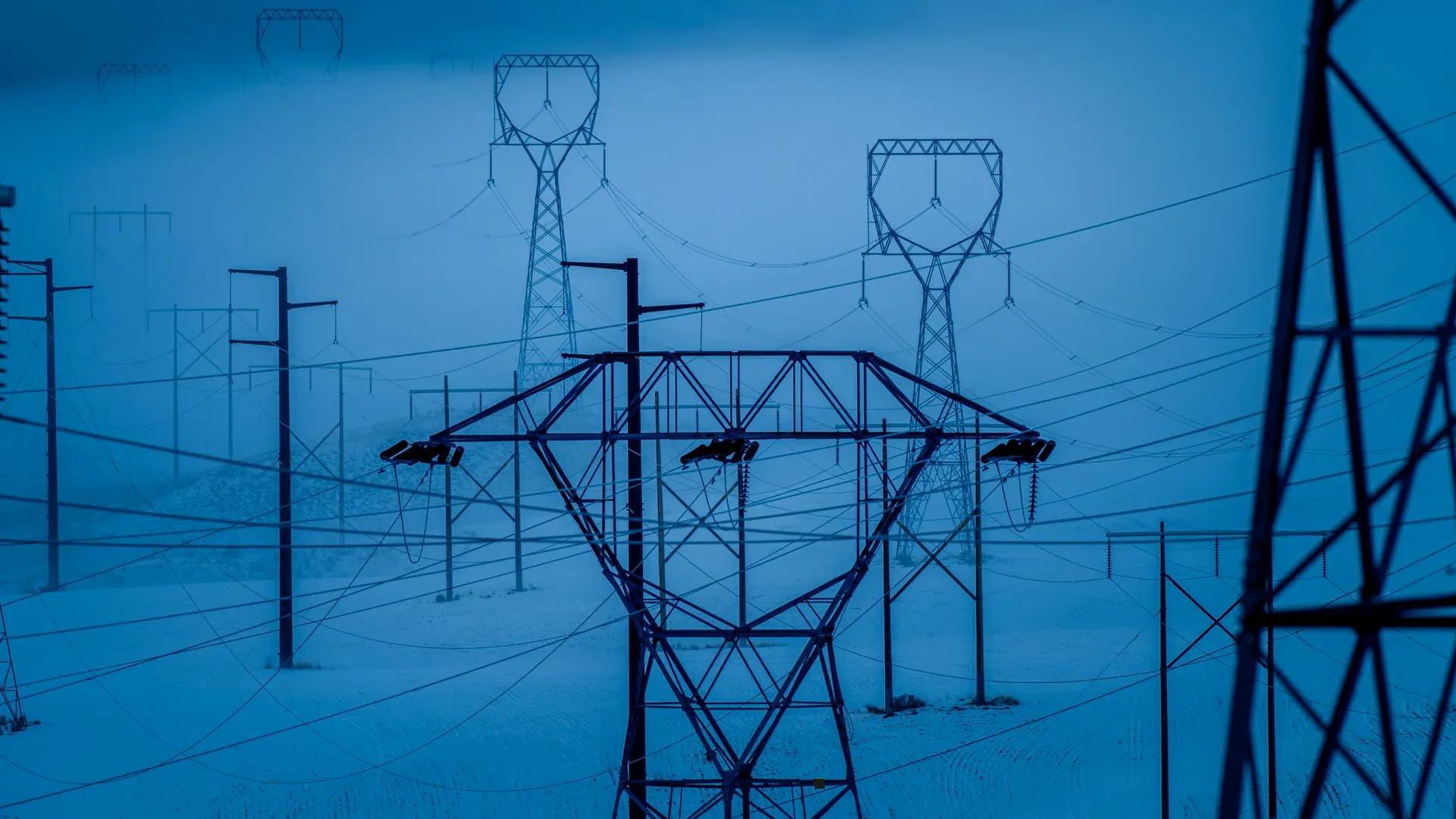 Transmission towers in snowy East Wenatchee, WA, during winter, showcasing electrical infrastructure