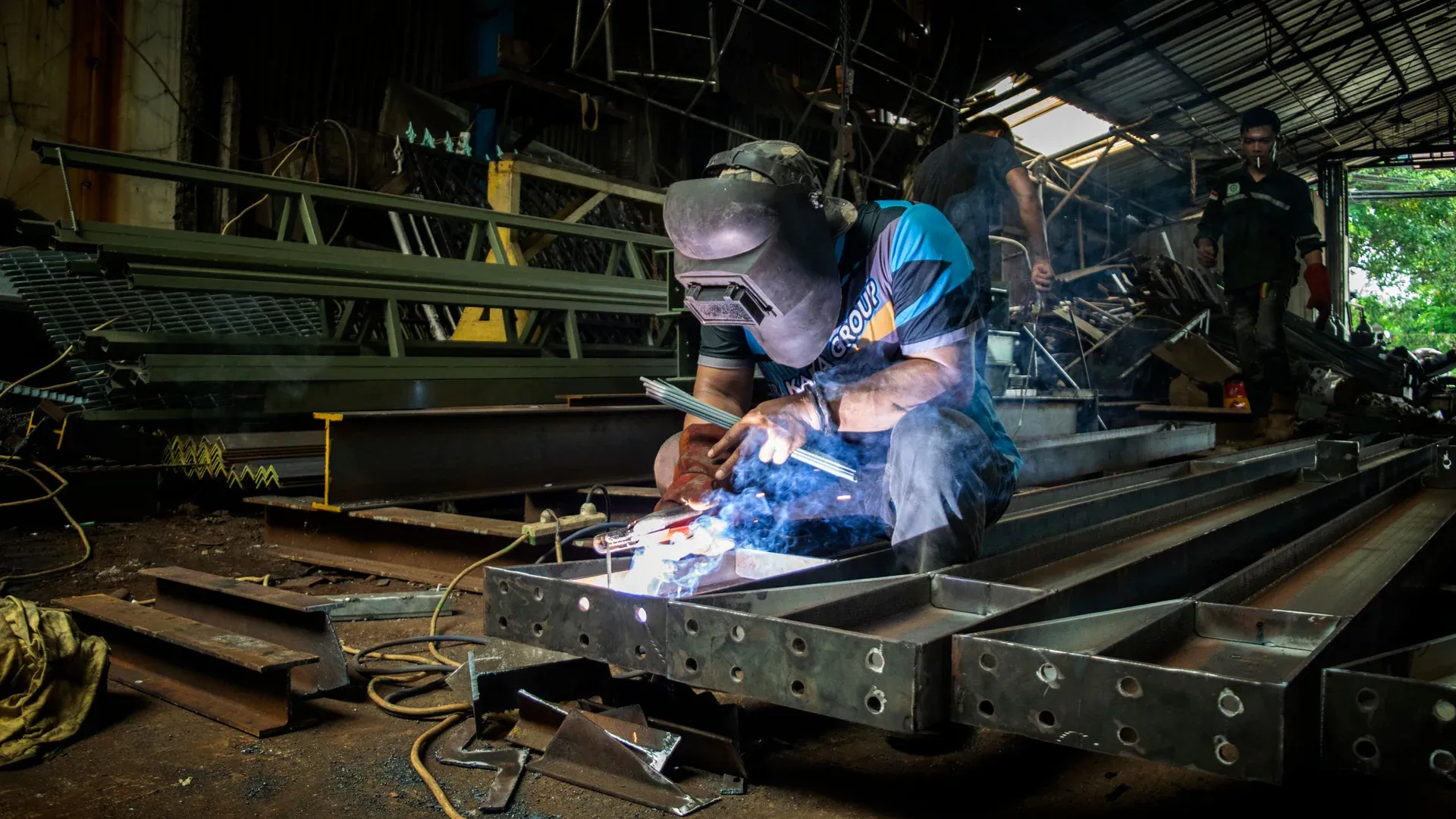 A professional welder demonstrates precision and skill in a metal workshop in Jakarta, Indonesia