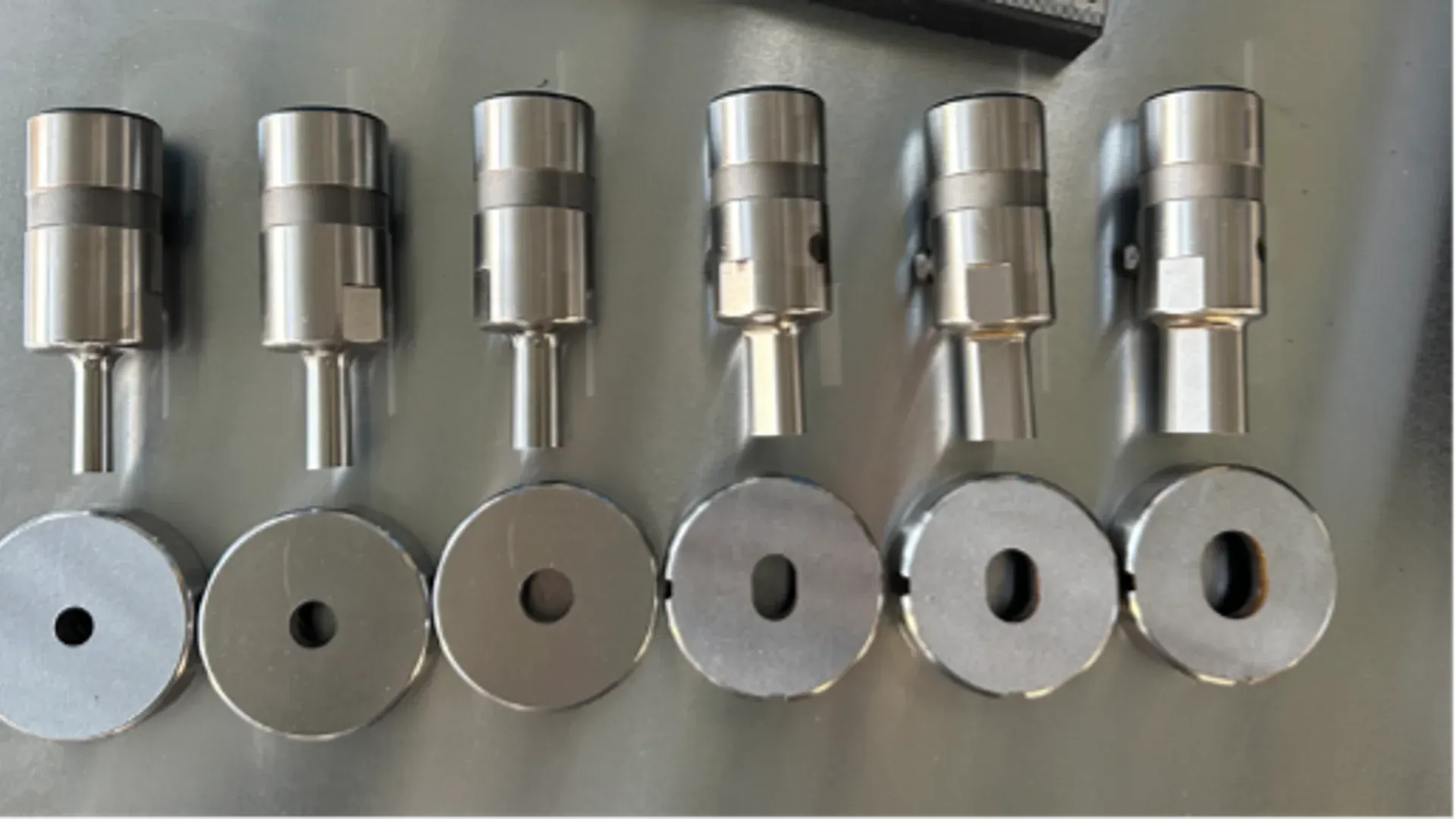 Matched busbar punches and dies arranged by feature size