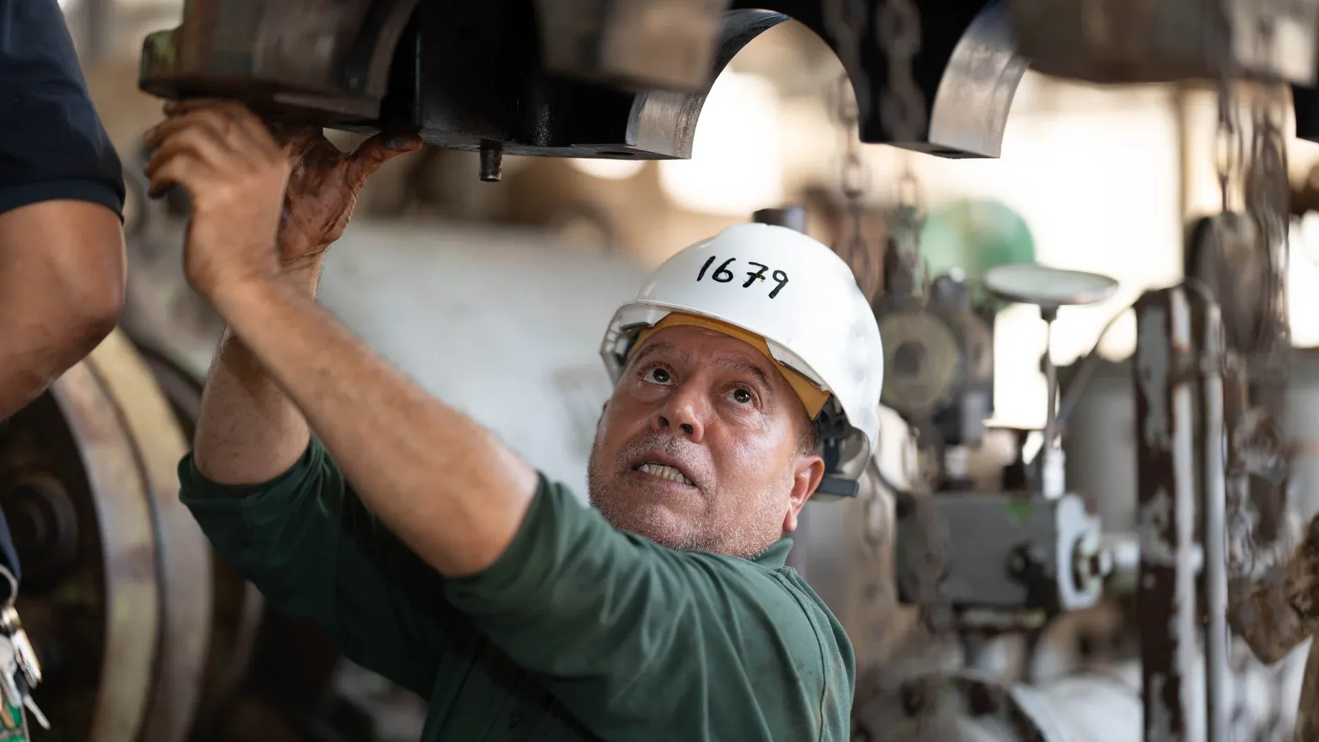 Engineer inspecting heavy industrial machinery before purchase