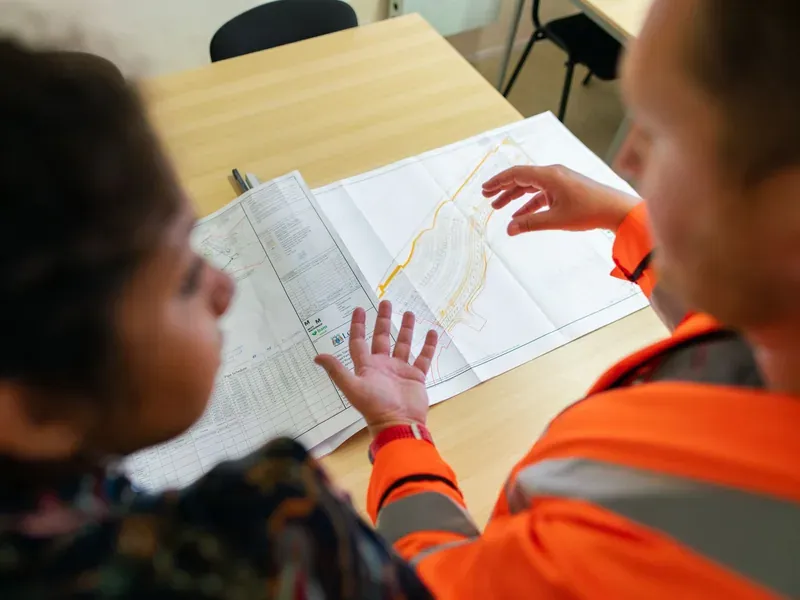 Engineering and procurement staff reviewing industrial project drawings
