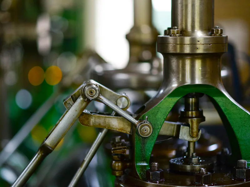 Detailed view of mechanical components in an industrial setting, showcasing metal gears and levers