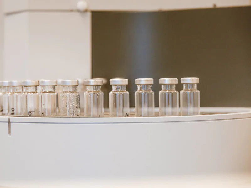 Close-up of empty glass vials arranged in a laboratory environment