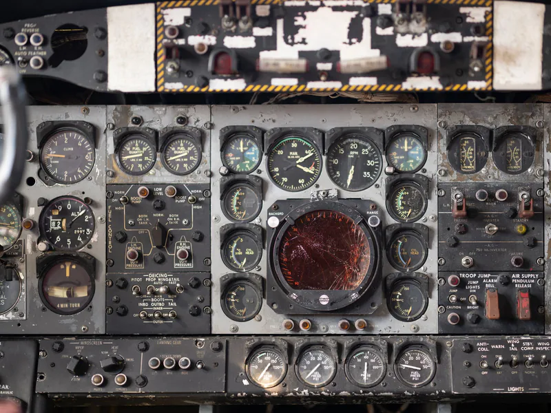 Close-up of a vintage aircraft cockpit control panel showcasing various dials and gauges