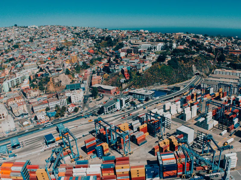 Explore a vibrant aerial view of Valparaíso, Chile, showcasing its bustling harbor and colorful hillside architecture