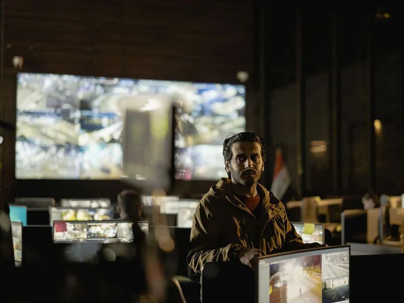 Modern security control room with a diverse team monitoring live surveillance feeds