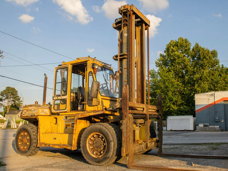 Heavy-duty yellow forklift parked outdoors in a Chesapeake, VA industrial area under clear skies