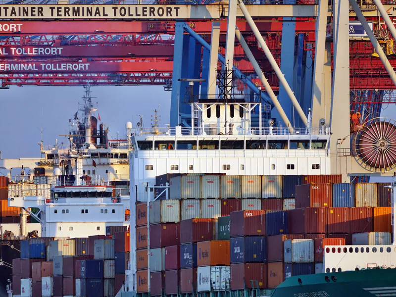 Container ships docked at Tollerort Terminal, Hamburg during sunset