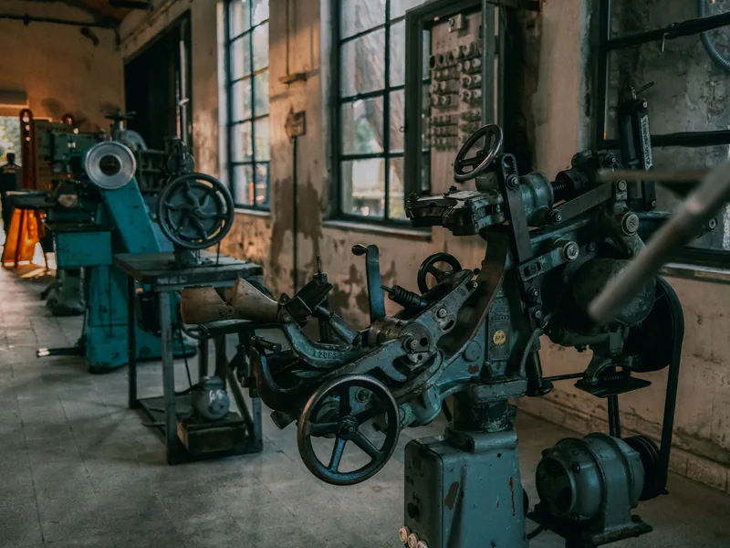 Old industrial machines in an abandoned workshop with vintage tools and equipment