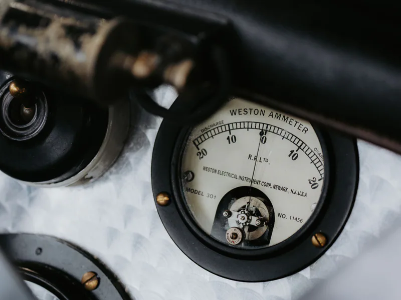 Detailed view of a vintage Weston ammeter gauge, showcasing intricate mechanical design in classic machinery