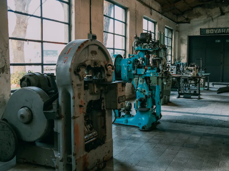 Interior of an old factory showcasing vintage machines and equipment