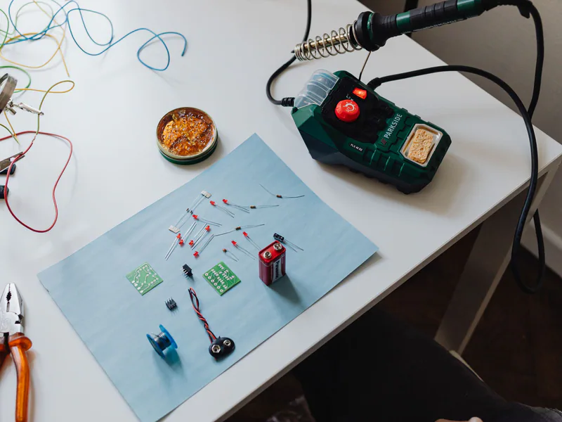 A workspace with a soldering station, tools, and electronic components ready for repair