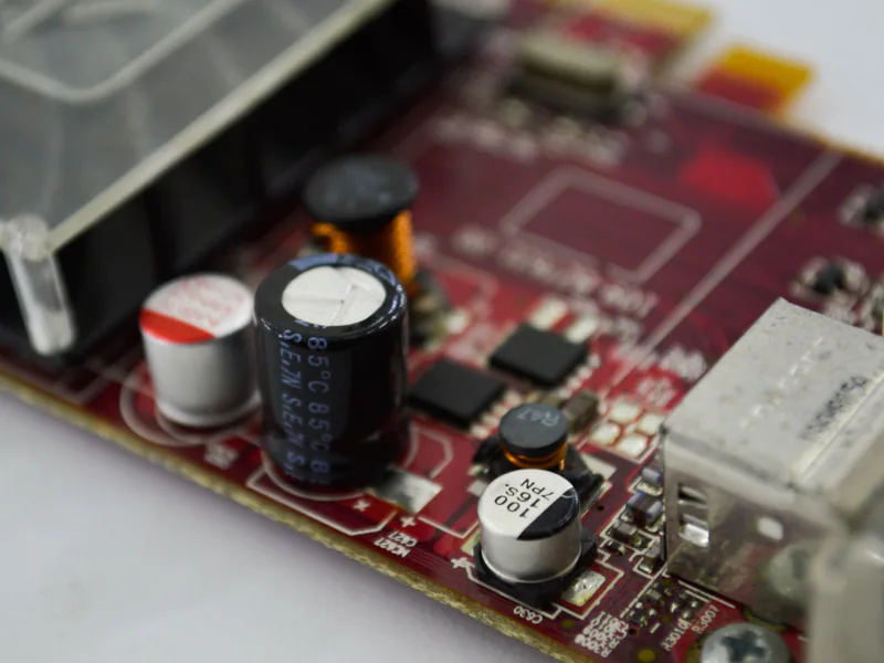 Detailed macro shot of a circuit board highlighting capacitors, chips, and circuits