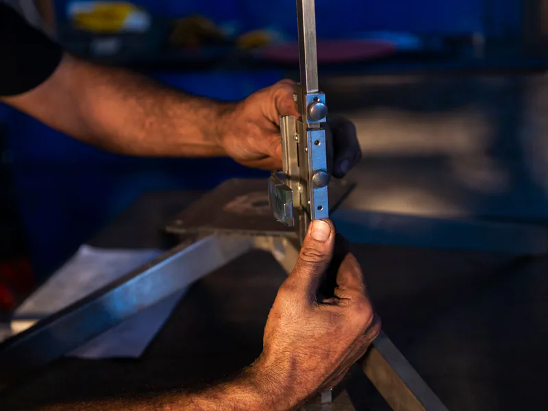 Close-up of hands focusing on precise metalwork using industrial tools in a workshop environment