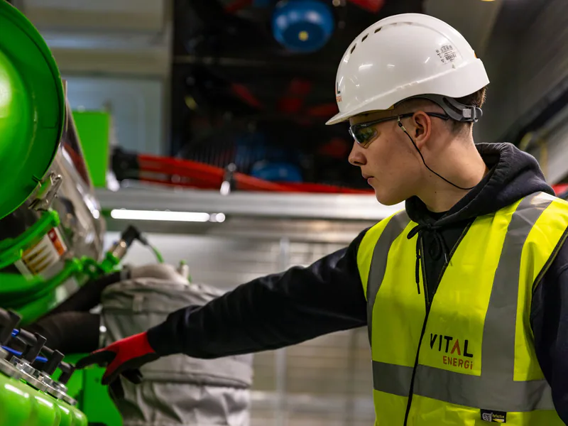 Maintenance technician diagnosing industrial production equipment