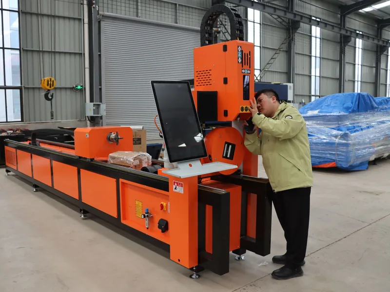 An operator setting up an industrial metal processing machine