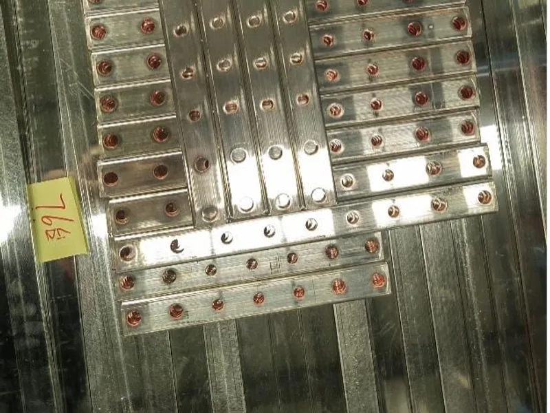 Finished plated busbar parts arranged for contact-surface inspection