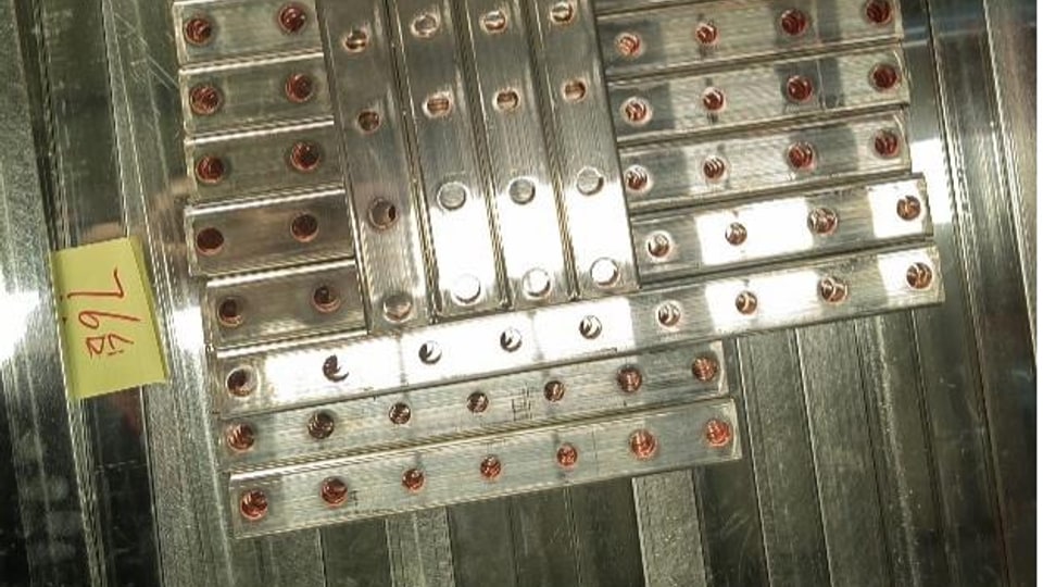 Bent copper busbar comparison sample used for conductivity and machining analysis