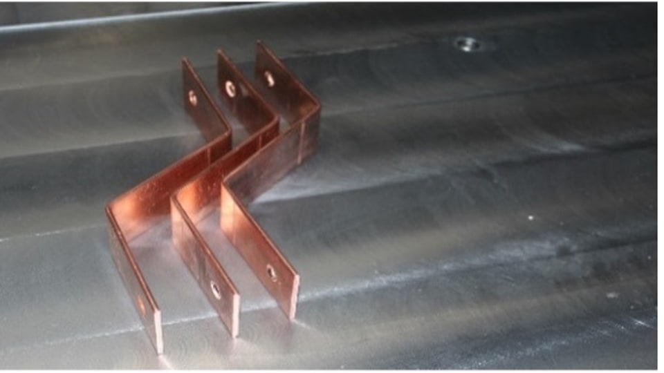 Precision-bent copper busbar profile for compact EV charging assemblies