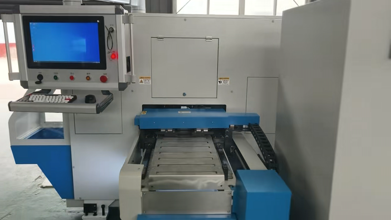 Close-up view of precision CNC multi-punch turret indexing station showing red copper busbar processing